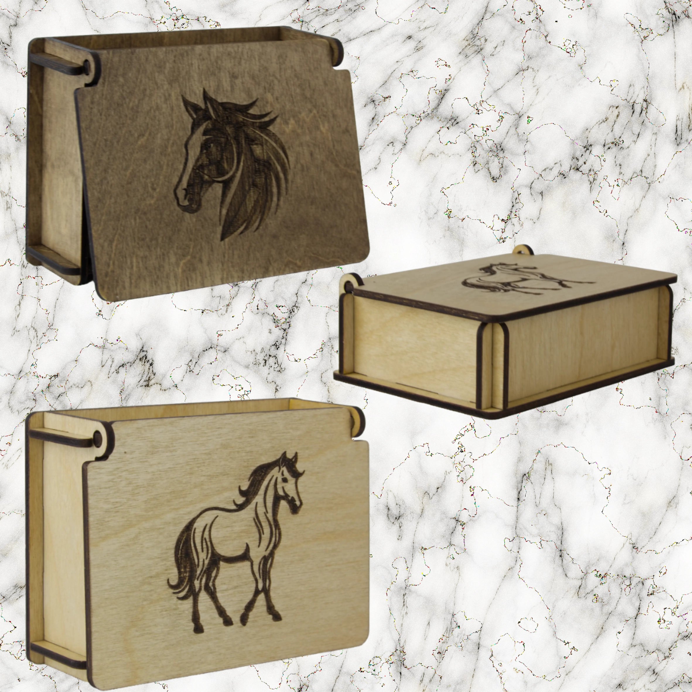 Three wooden boxes with horse engravings on a marble background