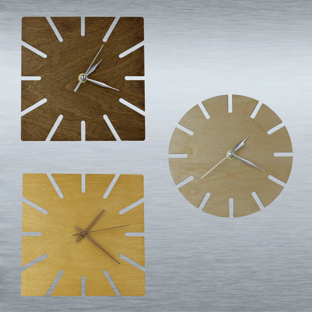 Three clocks of different shapes and colours on a silver background