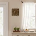 Dark brown square clock hanging on a wall next to a door