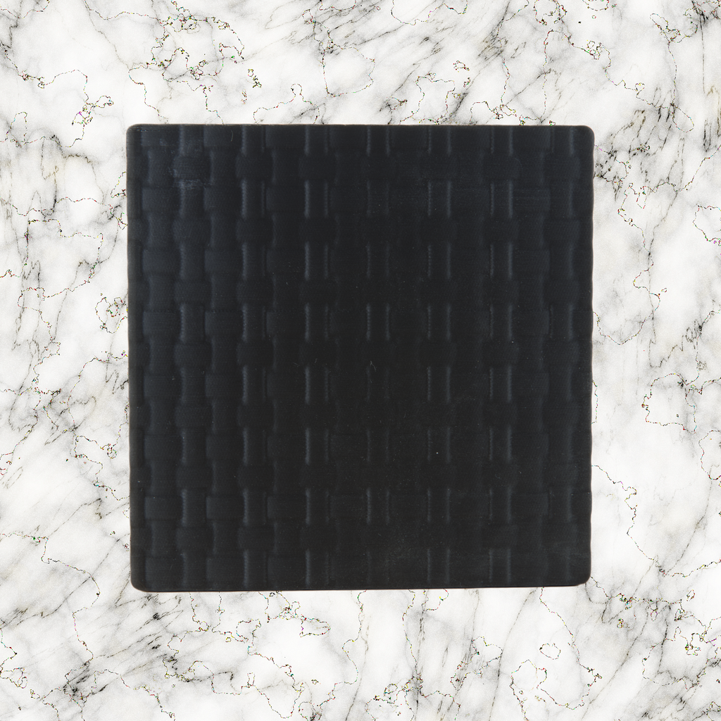 Black weave textured lightbox lid on a marble background