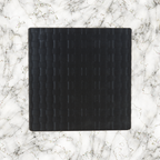 Black weave textured lightbox lid on a marble background