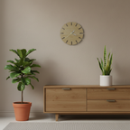 Light coloured round clock hanging on a wall above a sideboard