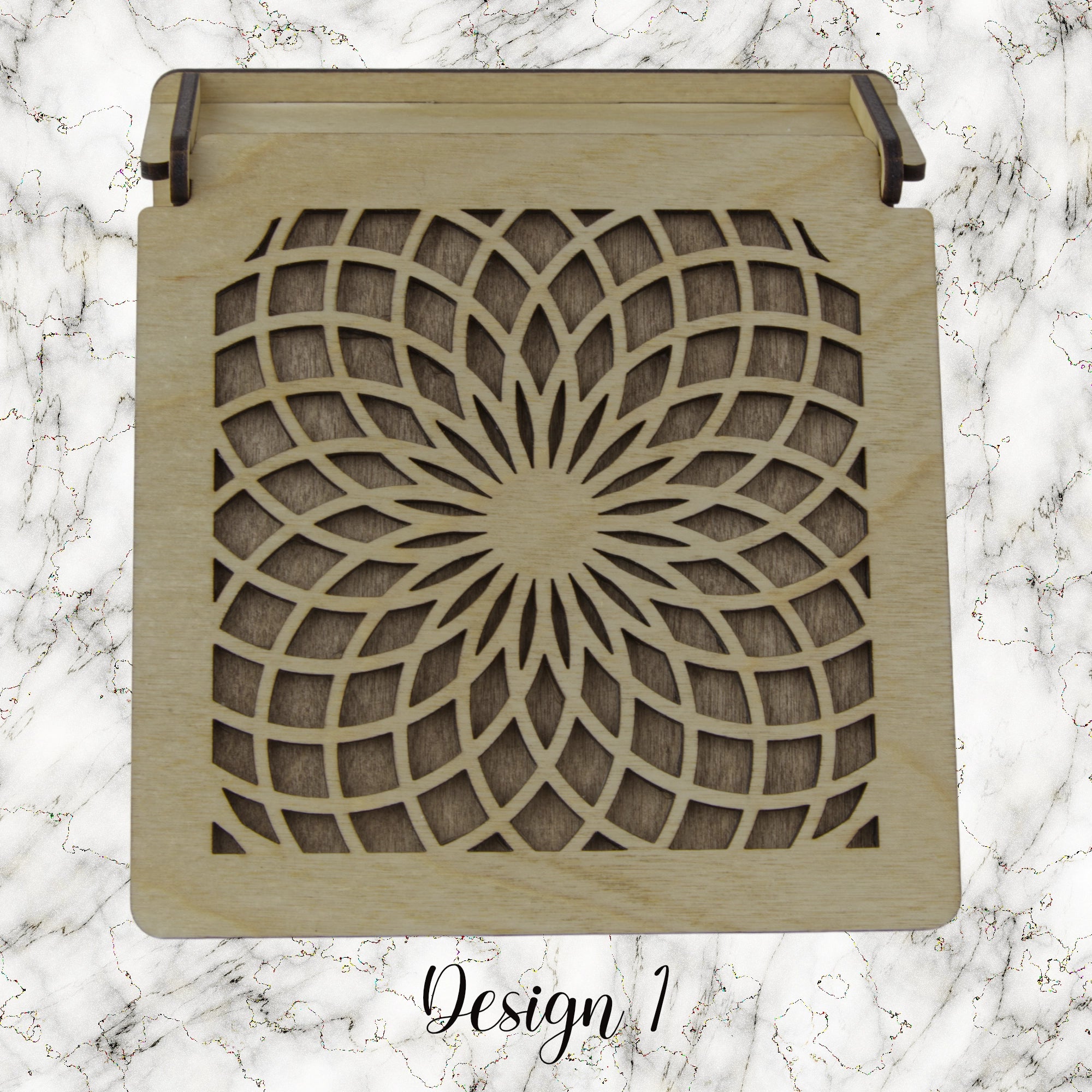 Decorative trinket box with pattered lid on a marble background
