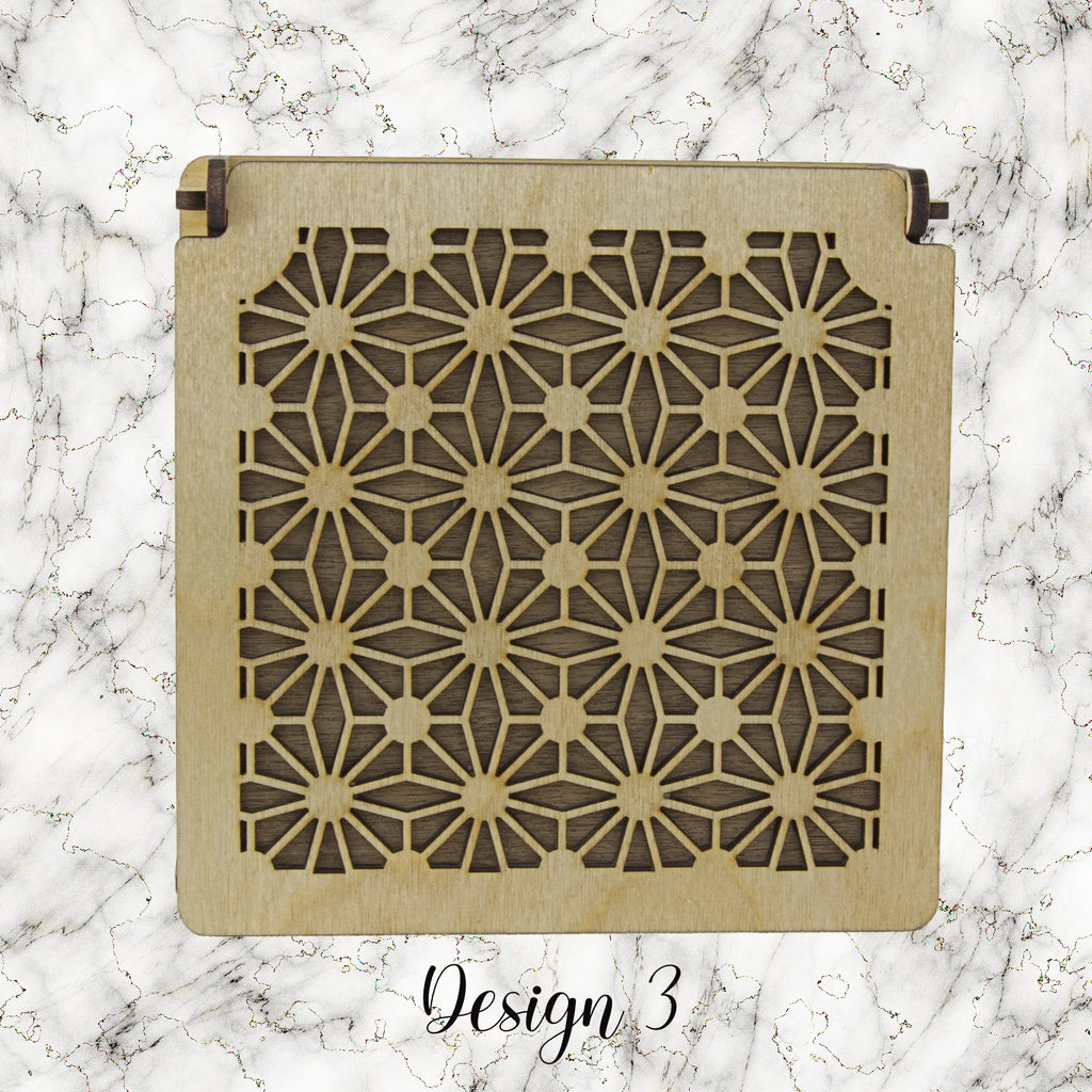 Decorative trinket box with pattered lid on a marble background