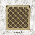 Decorative trinket box with pattered lid on a marble background