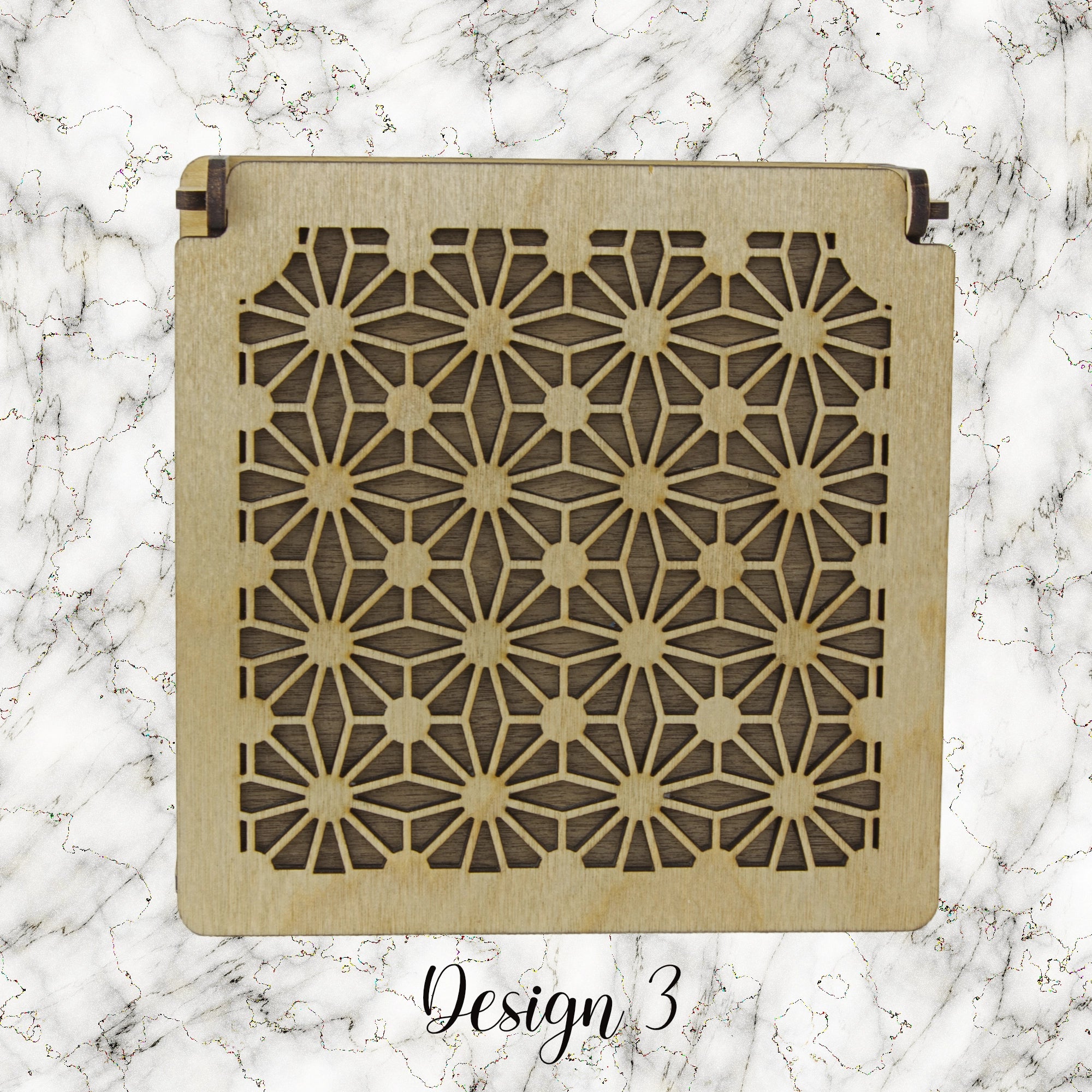 Decorative trinket box with pattered lid on a marble background