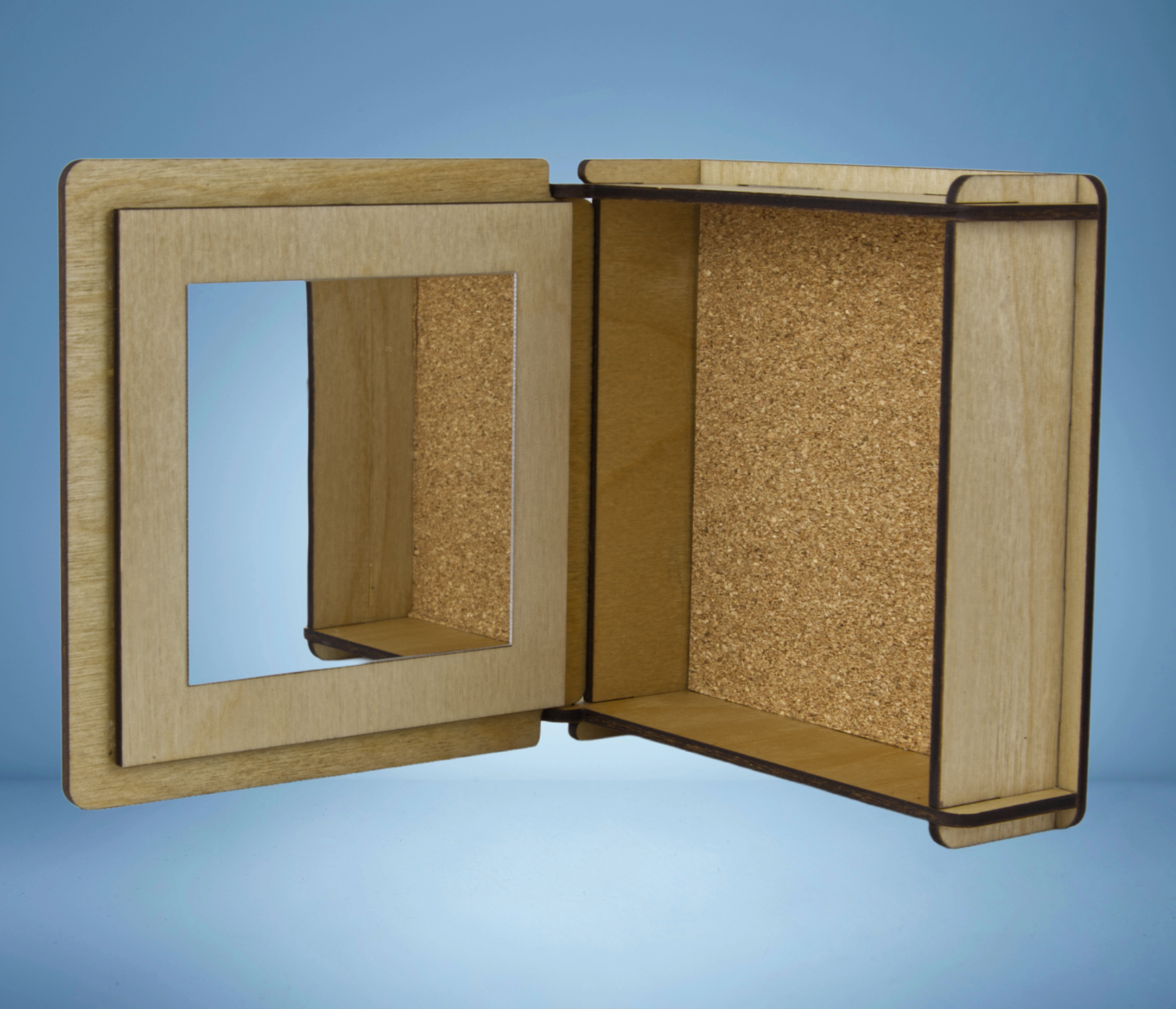 Decorative trinket box showing the inside with a mirror and cork bottom